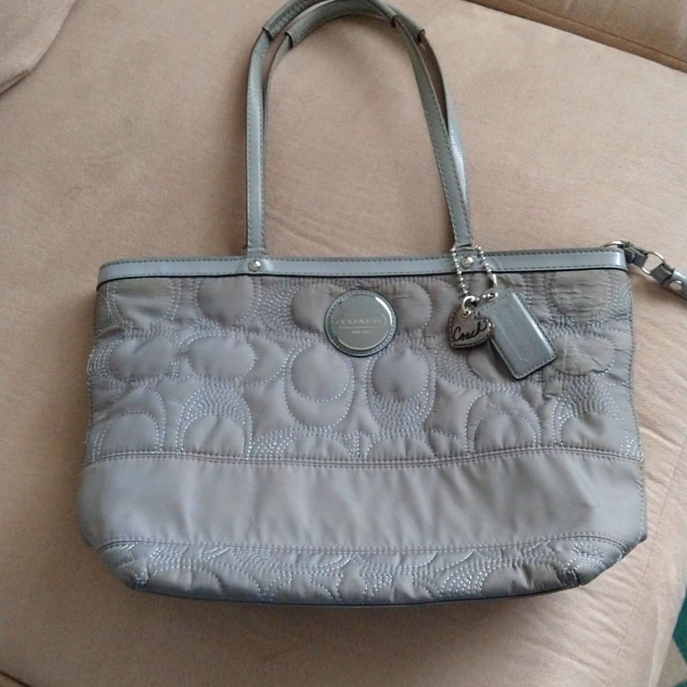 Coach bag in gray fabric with lavender interior.
